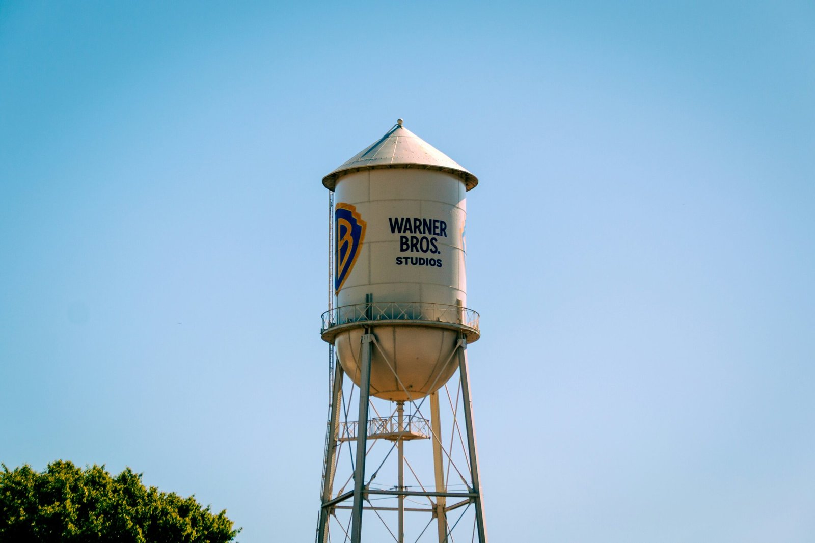 The warner bros. water tower against a blue sky.