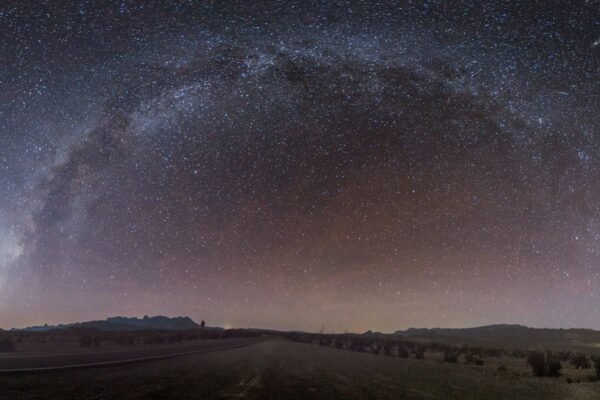 gray concrete road under sky full of stars