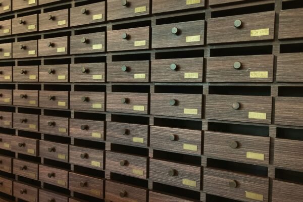 A wall full of many drawers in a room