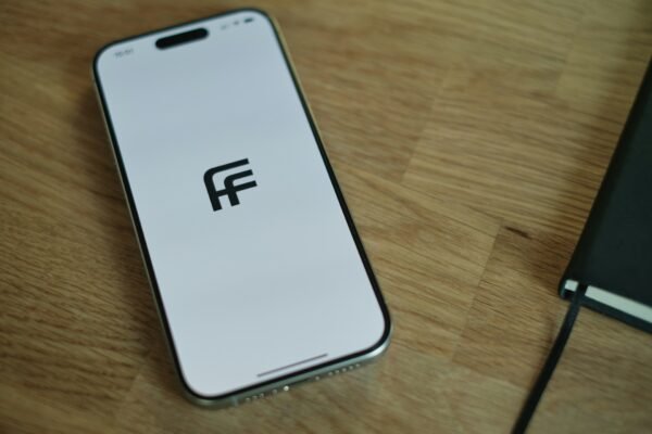 A cell phone sitting on top of a wooden table