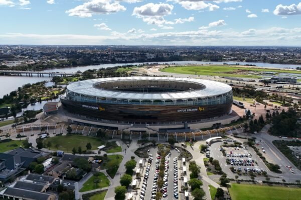 An aerial view of a stadium with a river in the background
