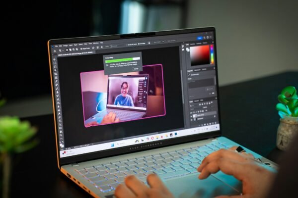 A person sitting at a table with a laptop