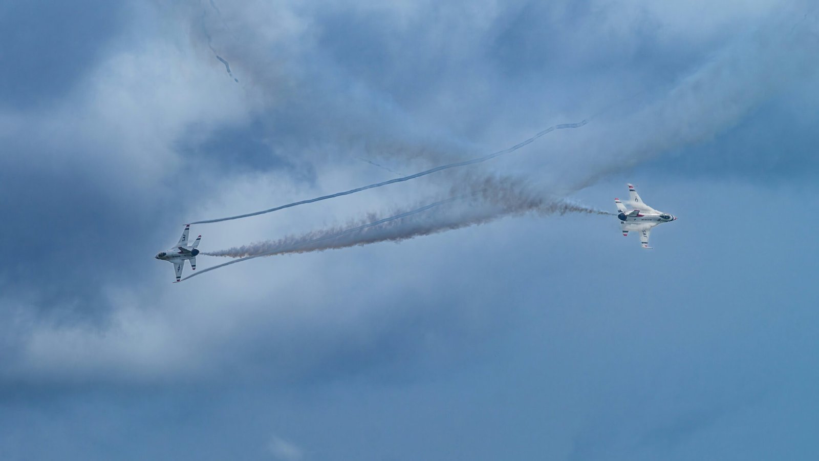 Two jets perform an impressive aerial maneuver.