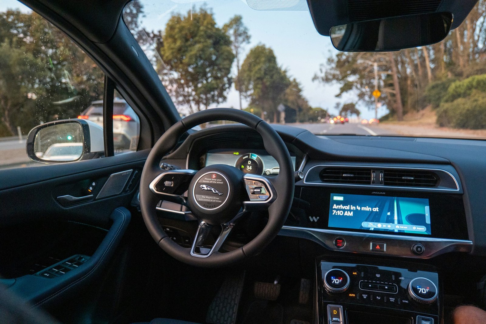 Inside a car, looking out at a road.