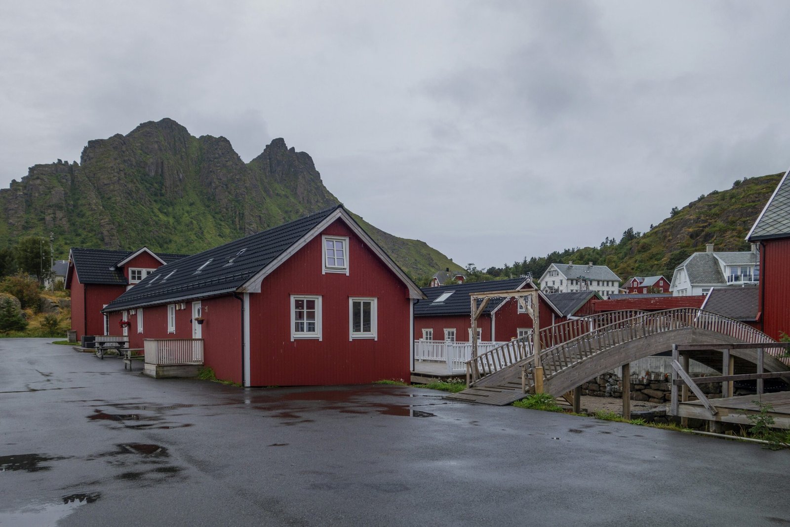 a row of red houses next to a mountain