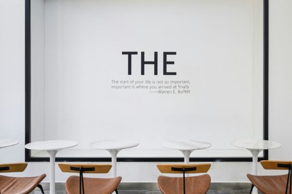 a group of chairs sitting in front of a white wall