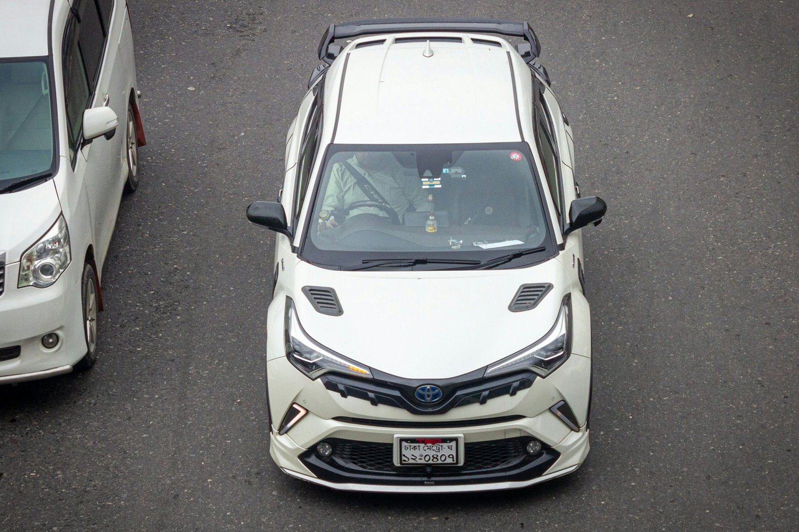 Two cars parked next to each other in a parking lot